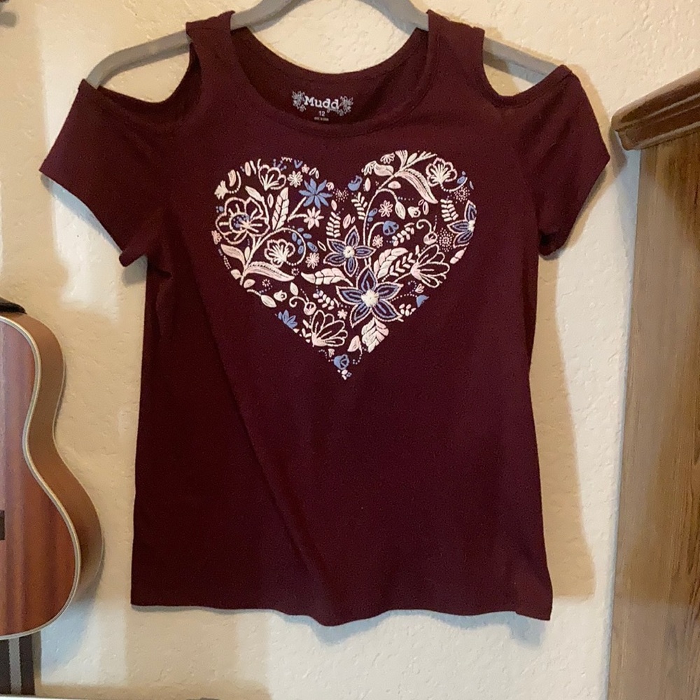 A maroon no shoulder short sleeve shirt